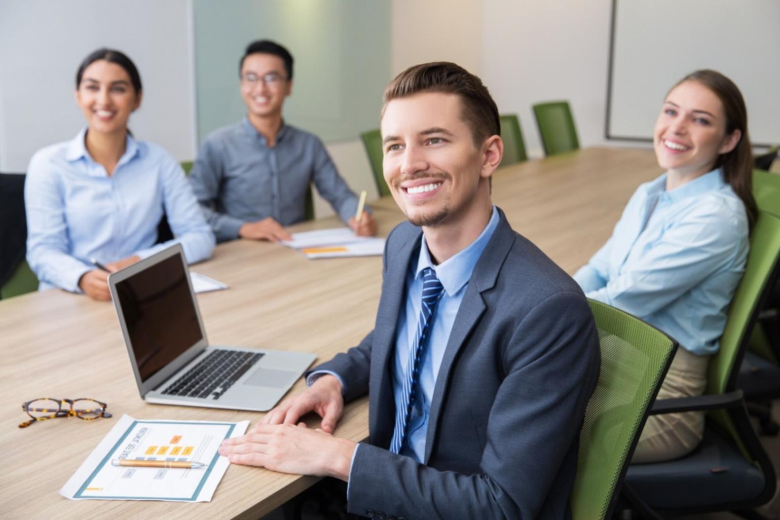 Professional discussing financial analysis with charts and documents